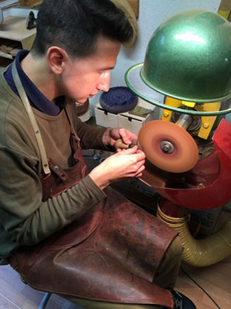 Fabian Joura sanding the mouthpiece on one of his pipes.