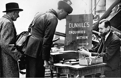 Henry Dunhill selling pipes amidst in the rubble.